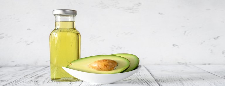 Bottle of avocado oil with fresh avocado