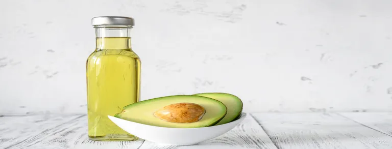 Bottle of avocado oil with fresh avocado Bottle of avocado oil with fresh avocado